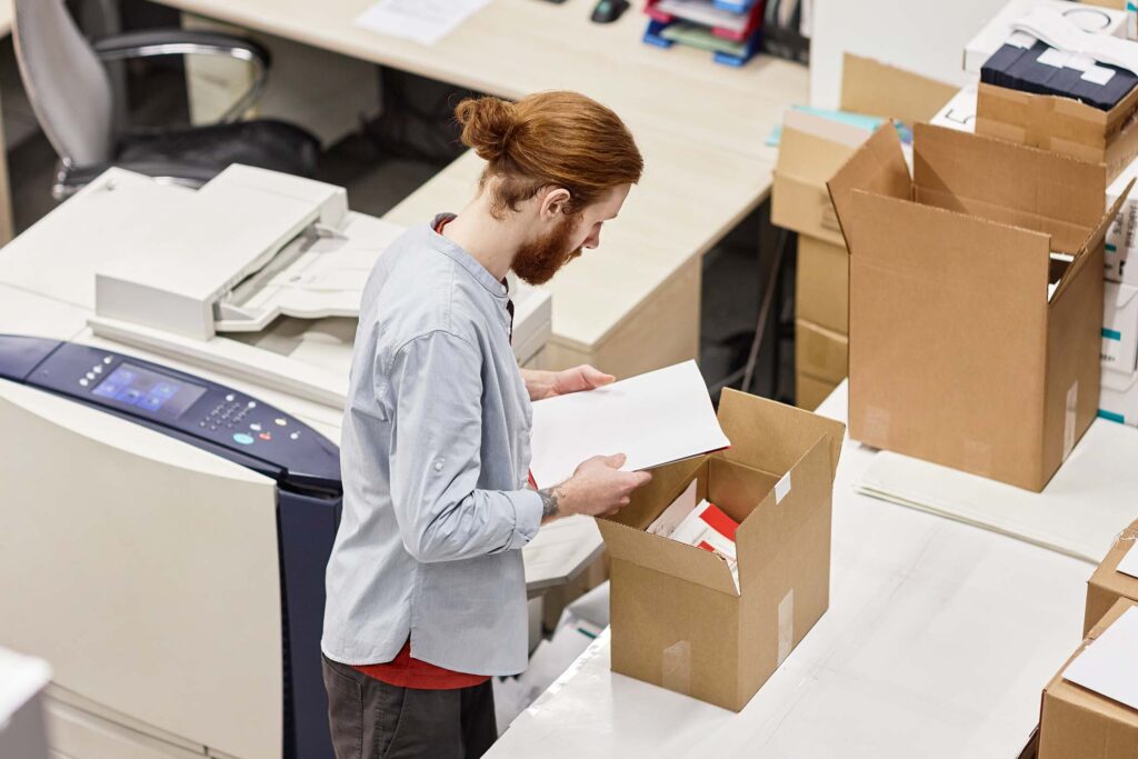 Man packaging boxes in brookefield